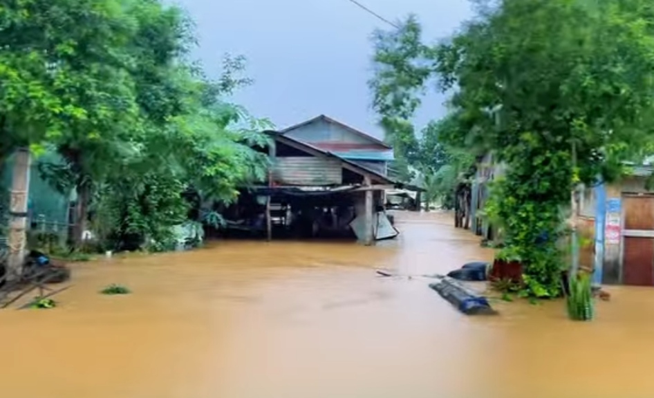 Flooded village street with stilt houses in Cambodia, September 2026
